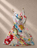 Y2K mini dress с draped cowl neckline и супер характерен цветен graphic принт в стил early-2000s pop art
